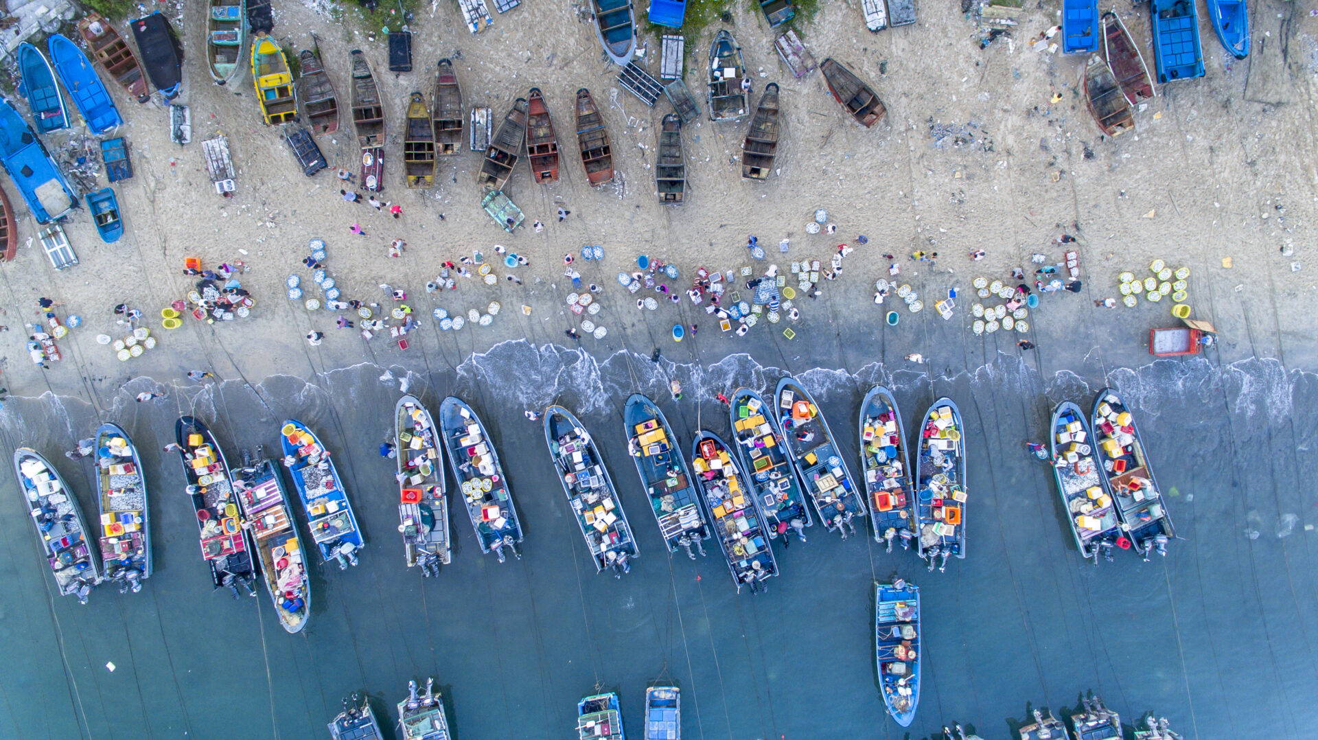 Bird’s eye view of fishing market on beach, China
