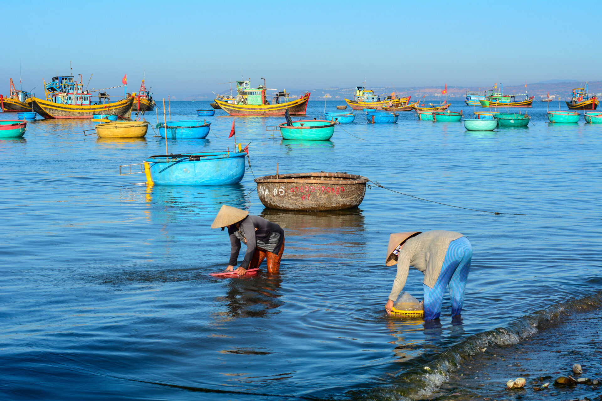 Women with traditional hats working at village